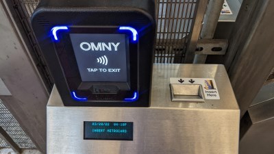 Top view of the AutoGate machine reader with an OMNY reader and a slot for the MetroCard